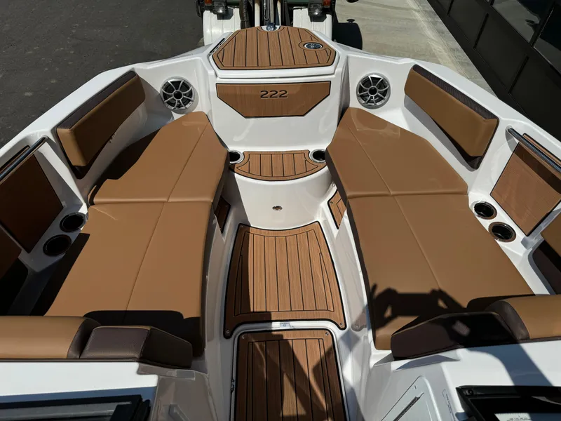 Slide: The Image of 2024 Yamaha 222SD jet boat interior with tan seating and wood accents. - 6