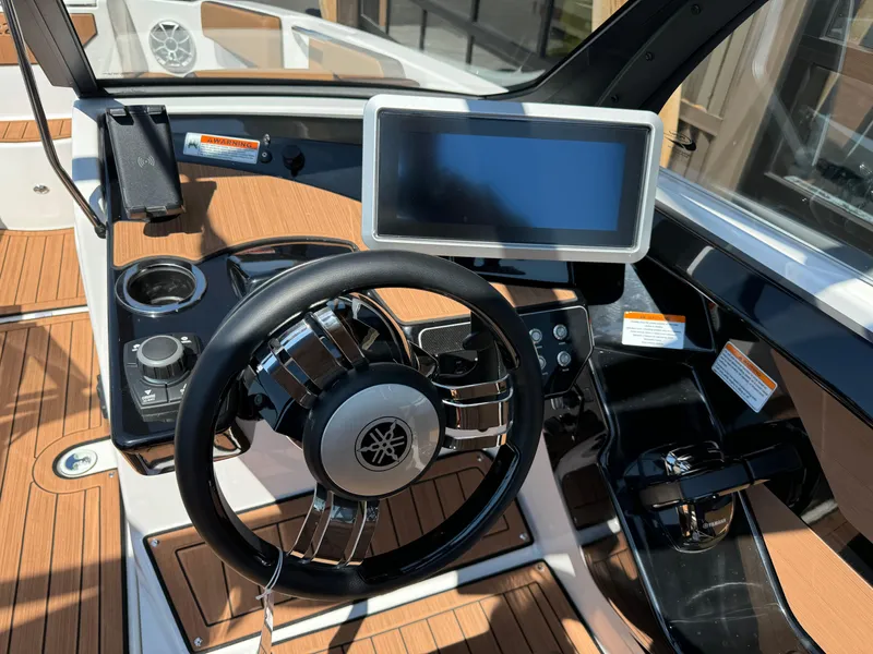 Slide: The Image of 2024 Yamaha 222SD jet boat dashboard with steering wheel and touchscreen display. - 8