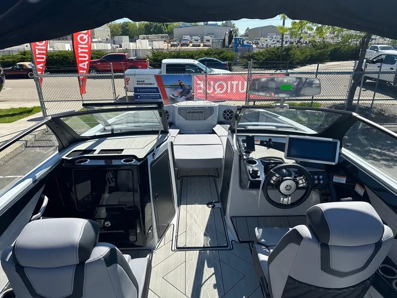 Slide: The Image of 2024 Yamaha 222XD jet boat interior with modern dashboard and seating. - 11