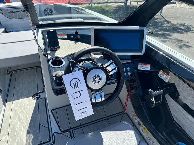 Slide: The Image of 2024 Yamaha 222XD jet boat cockpit with steering wheel and digital display. - 12