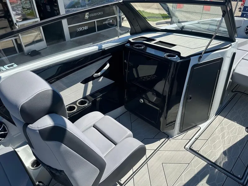 Slide: The Image of 2024 Yamaha 222XD jet boat interior with sleek seating and modern dashboard design. - 15