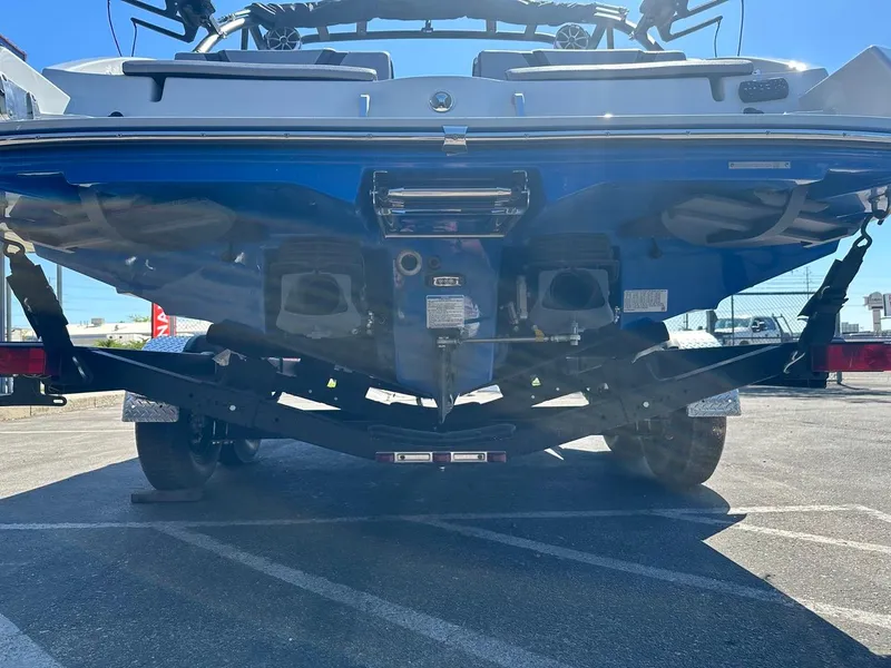 Slide: The Image of 2024 Yamaha 222XD jet boat rear view on trailer in sunlight. - 8