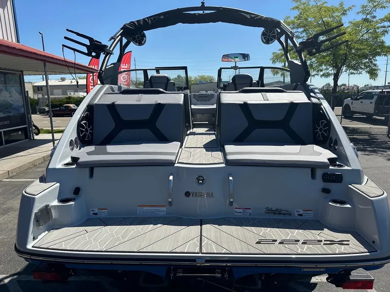 Slide: The Image of 2024 Yamaha 222XD jet boat rear view, showcasing seating and deck features. - 9