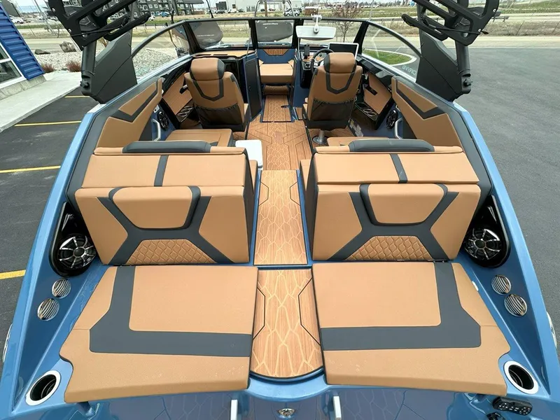 Slide: The Image of 2024 Yamaha 222XD jet boat interior with tan and black seating, modern design. - 10