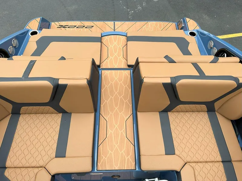 Slide: The Image of 2024 Yamaha 222XD jet boat interior with tan and gray seating, stylish design. - 11