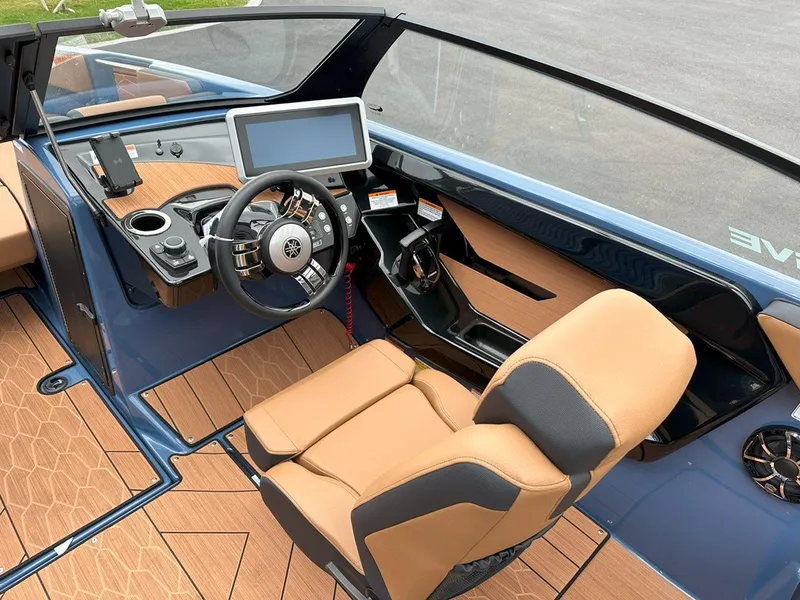 Slide: The Image of 2024 Yamaha 222XD jet boat cockpit with modern controls and tan seating. - 12