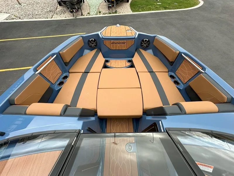 Slide: The Image of 2024 Yamaha 222XD jet boat interior with tan and blue seating. - 14