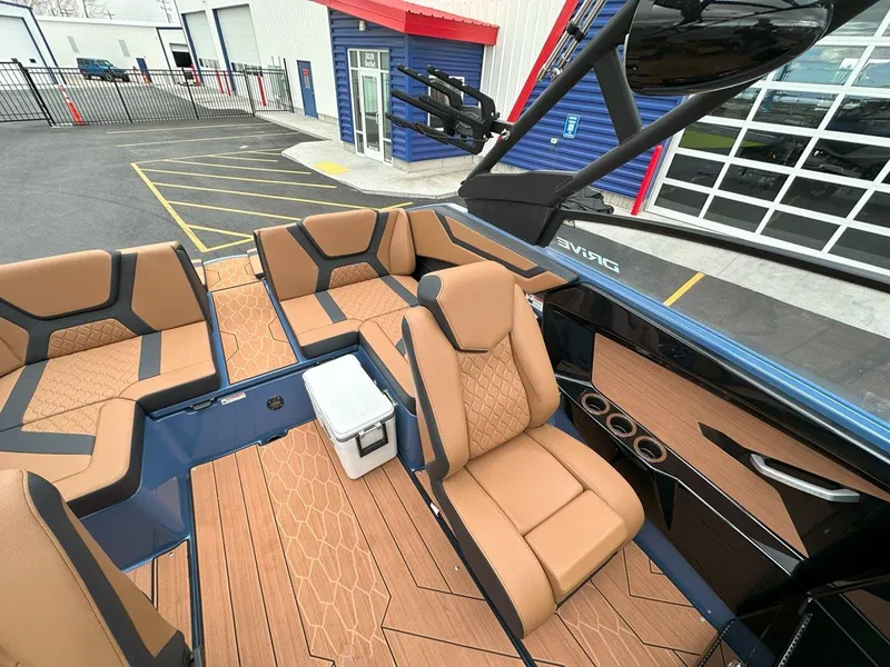 Slide: The Image of 2024 Yamaha 222XD jet boat interior with tan seating and wood accents. - 15