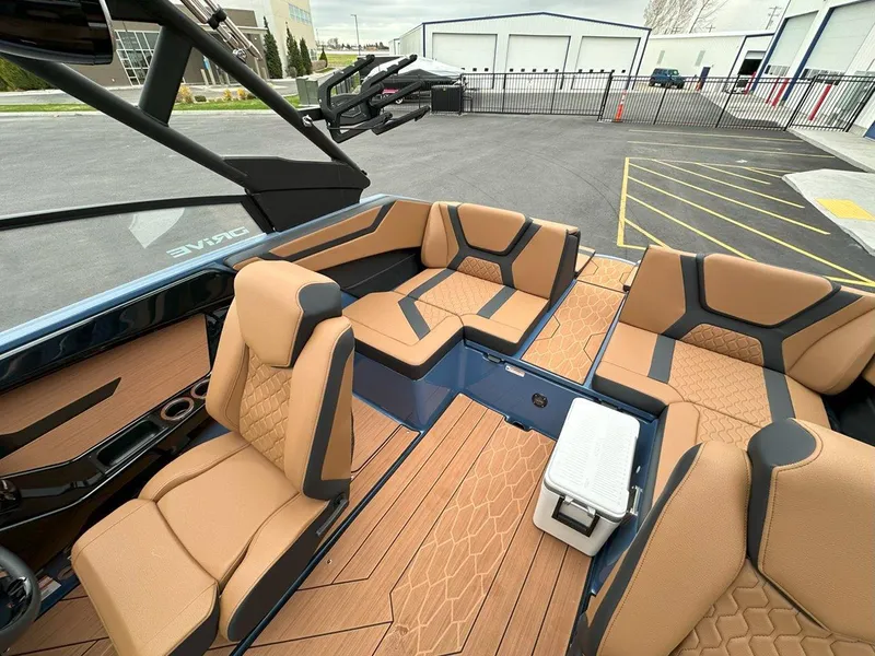 Slide: The Image of 2024 Yamaha 222XD jet boat interior with tan seating and modern design. - 16