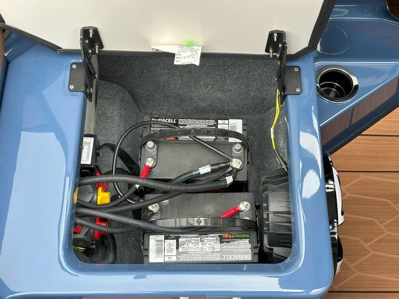 Slide: The Image of 2024 Yamaha 222XD jet boat battery compartment with Duracell batteries and wiring. - 18
