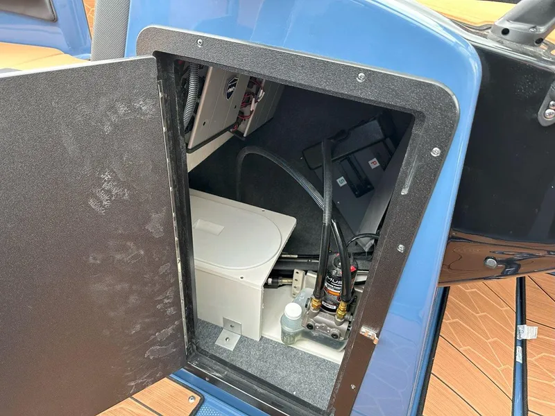Slide: The Image of 2024 Yamaha 222XD jet boat storage compartment with equipment and wiring. - 20