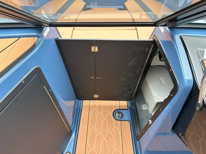Slide: The Image of 2024 Yamaha 222XD jet boat interior storage compartment with wood finish. - 21