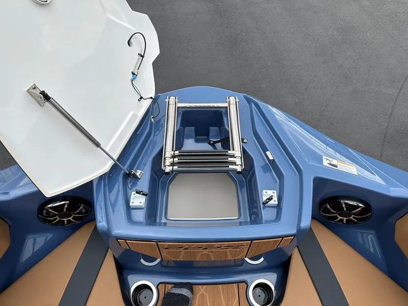 Slide: The Image of 2024 Yamaha 222XD jet boat interior with open storage compartment and speakers. - 22