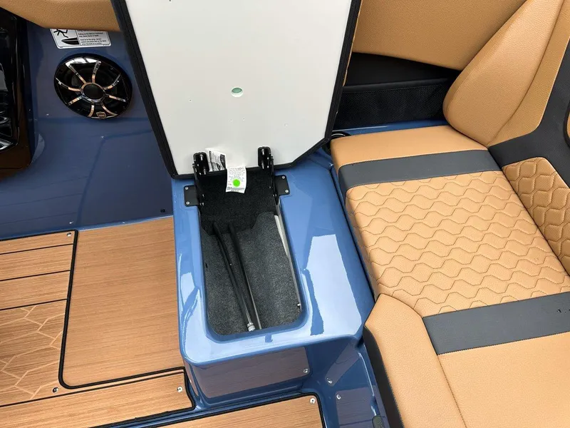 Slide: The Image of 2024 Yamaha 222XD jet boat interior with tan seating and storage compartment. - 23