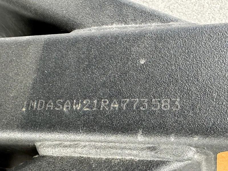 Slide: The Image of Close-up of a 2024 Yamaha 222XD jet boat's serial number engraving. - 26