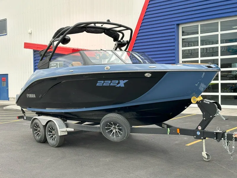Slide: The Image of 2024 Yamaha 222XD jet boat on trailer, parked outside a building. - 3