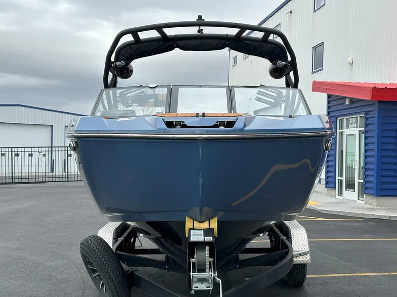 Slide: The Image of 2024 Yamaha 222XD jet boat on trailer, parked outside a building. - 4