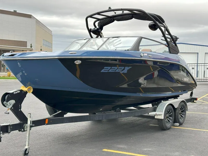 Slide: The Image of 2024 Yamaha 222XD jet boat on trailer, sleek design, parked outdoors. - 5