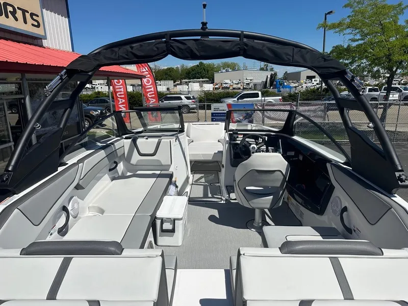 Slide: The Image of 2024 Yamaha AR220 jet boat interior with sleek seating and modern dashboard. - 11