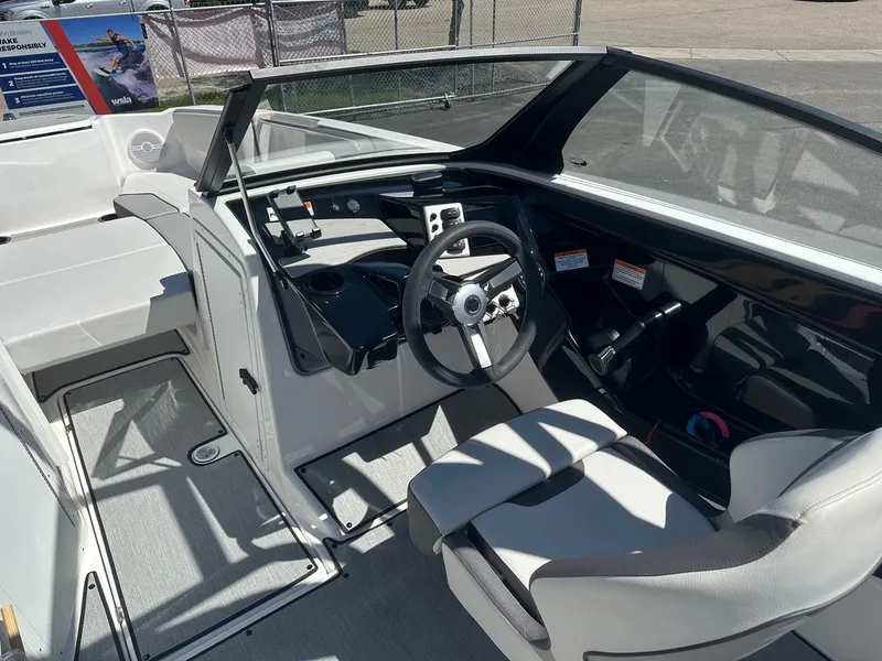 Slide: The Image of 2024 Yamaha AR220 jet boat interior with steering wheel and seating. - 12