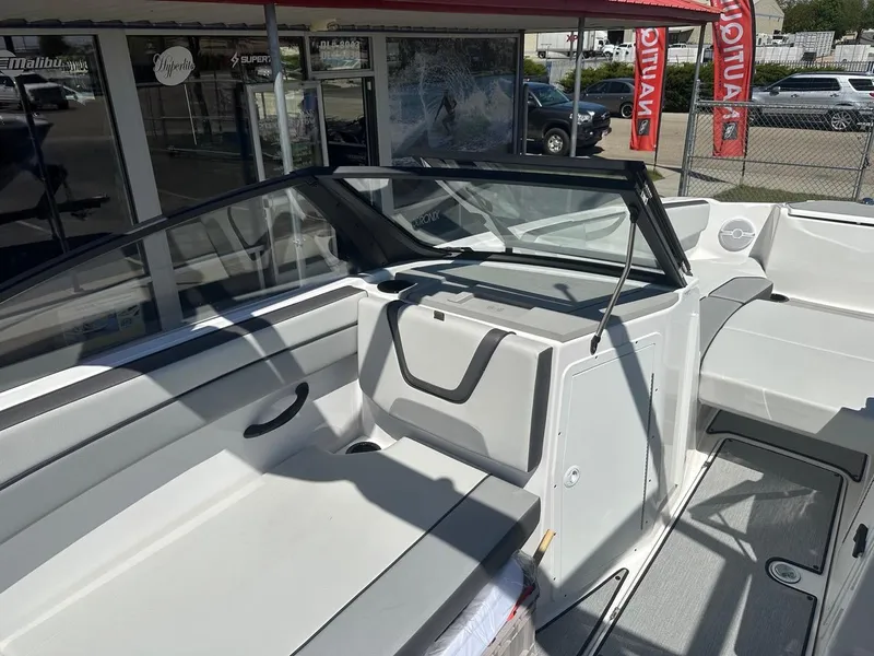 Slide: The Image of 2024 Yamaha AR220 jet boat interior with seating and windshield, displayed at a dealership. - 13