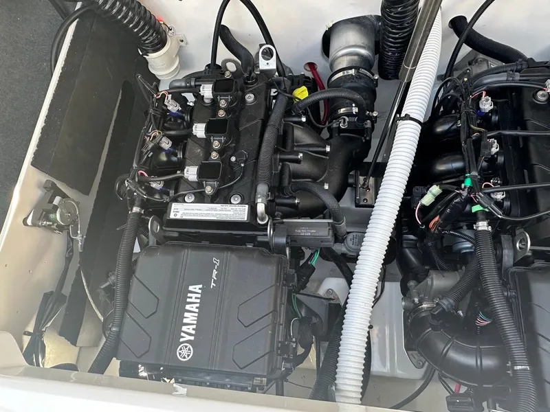 Slide: The Image of 2024 Yamaha AR220 jet boat engine compartment with visible components and wiring. - 22