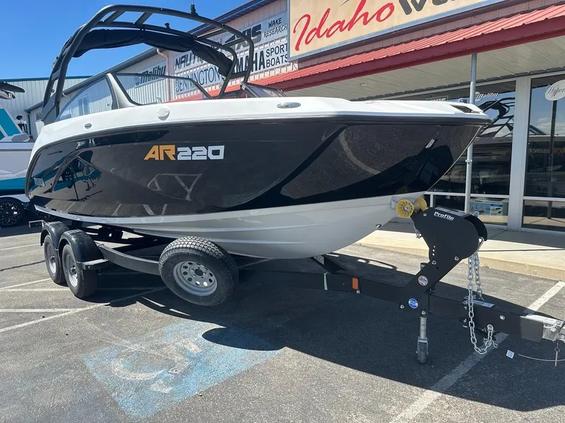 Slide: The Image of 2024 Yamaha AR220 jet boat on trailer, displayed outdoors at dealership. - 3