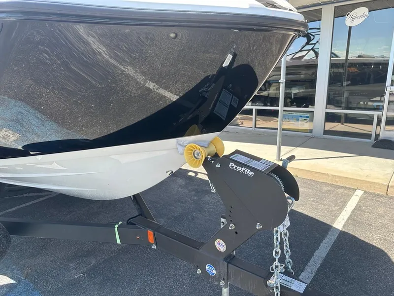 Slide: The Image of 2024 Yamaha AR220 jet boat on trailer, parked outside dealership. - 4