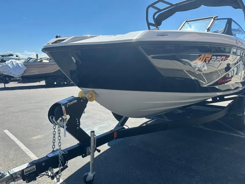 Slide: The Image of 2024 Yamaha AR220 jet boat on trailer under clear blue sky. - 5