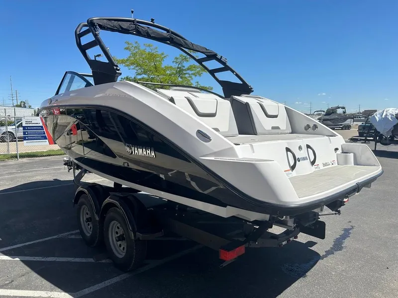 Slide: The Image of 2024 Yamaha AR220 jet boat on trailer, sleek design, parked outdoors under clear sky. - 7