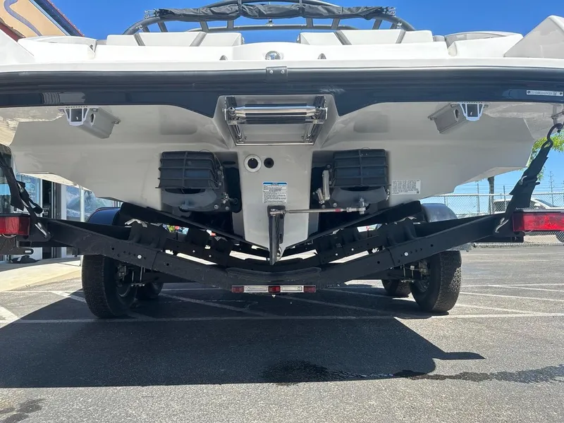 Slide: The Image of 2024 Yamaha AR220 jet boat rear view on trailer in parking lot. - 8