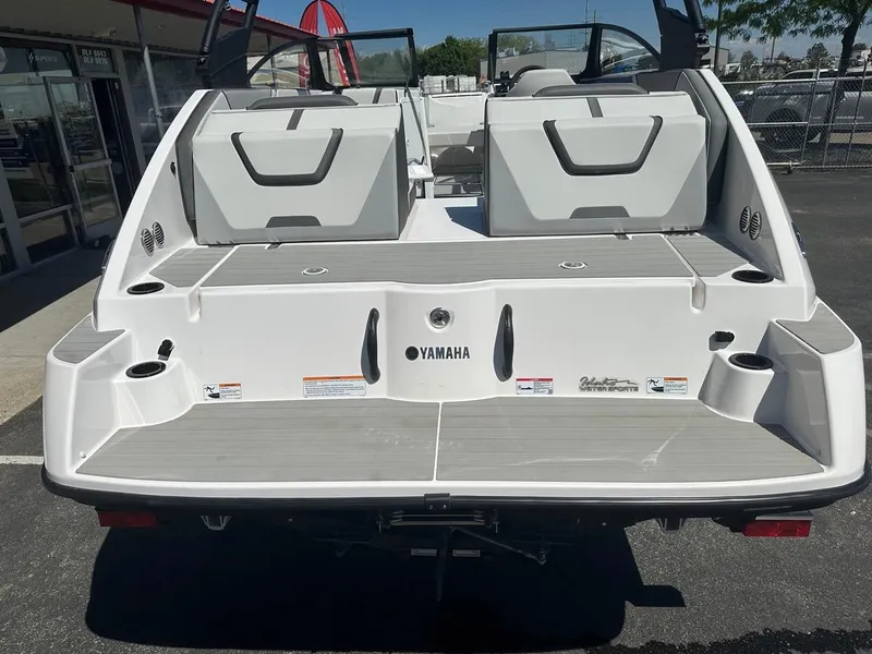 Slide: The Image of 2024 Yamaha AR220 jet boat rear view, showcasing swim platform and seating. - 9