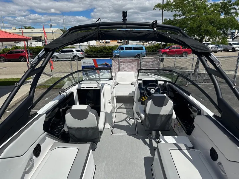 Slide: The Image of 2024 Yamaha AR250 jet boat interior with sleek seating and modern dashboard. - 11