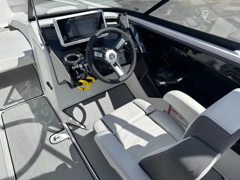Slide: The Image of 2024 Yamaha AR250 jet boat cockpit with steering wheel and digital display. - 12