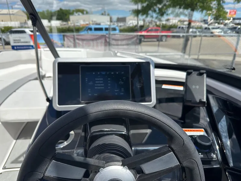 Slide: The Image of 2024 Yamaha AR250 jet boat dashboard with steering wheel and touchscreen display. - 13