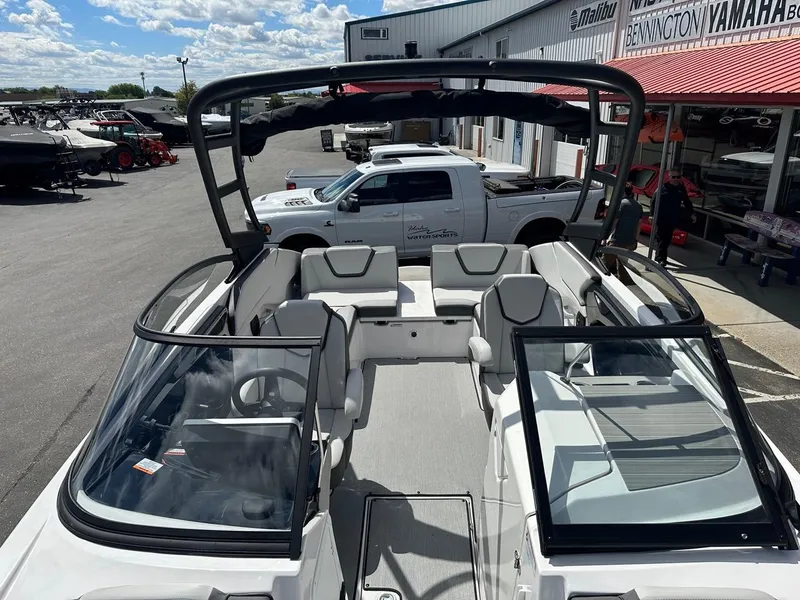 Slide: The Image of 2024 Yamaha AR250 jet boat interior at dealership, showcasing seating and windshield design. - 19