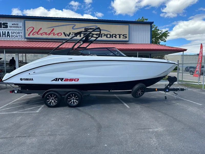 Slide: The Image of 2024 Yamaha AR250 jet boat on trailer at Idaho Water Sports dealership. - 2