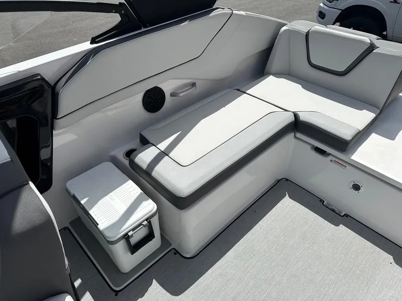 Slide: The Image of 2024 Yamaha AR250 jet boat interior with cushioned seating and storage compartment. - 20