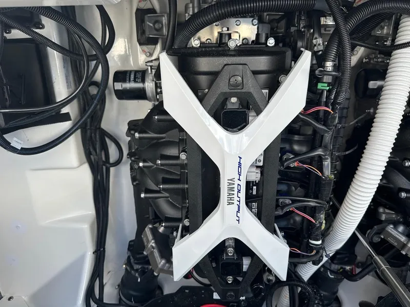 Slide: The Image of 2024 Yamaha AR250 engine compartment showcasing high output components and wiring. - 23