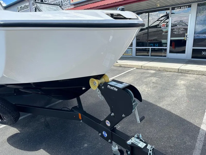 Slide: The Image of 2024 Yamaha AR250 jet boat on trailer outside dealership. - 4