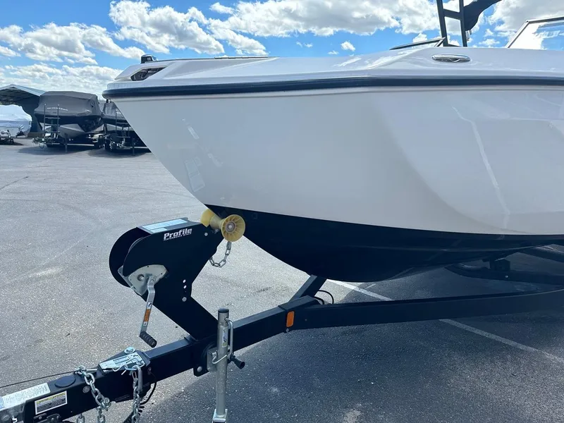 Slide: The Image of 2024 Yamaha AR250 jet boat on trailer under a blue sky. - 5