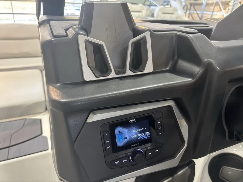 Slide: The Image of 2025 Axis A225 boat dashboard with Bluetooth-enabled audio system and phone holder. - 13