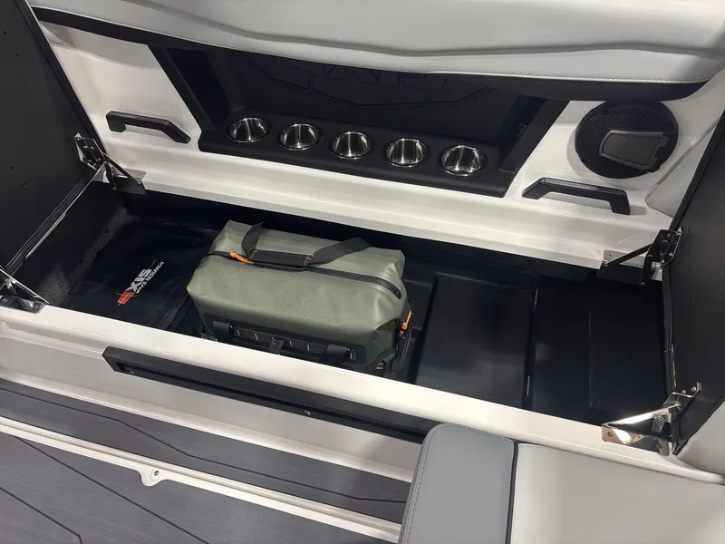 Slide: The Image of 2025 Axis A225 boat storage compartment with bag and cup holders. - 15