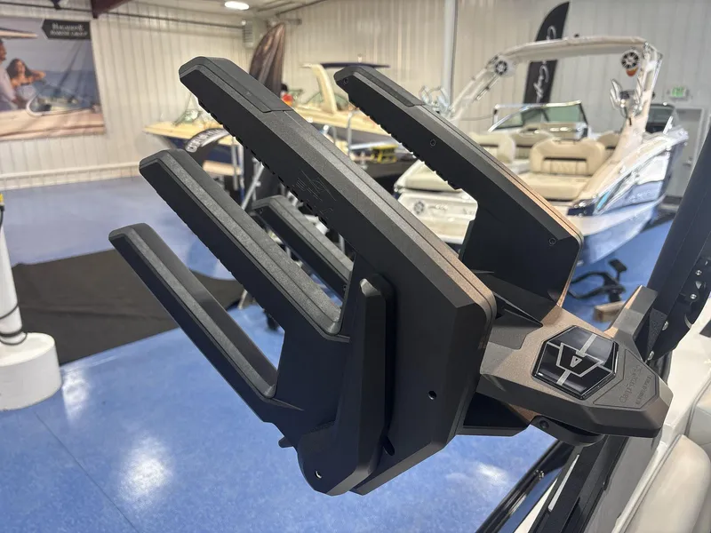 Slide: The Image of 2025 Axis A225 boat with a close-up of a wakeboard rack in a showroom. - 17