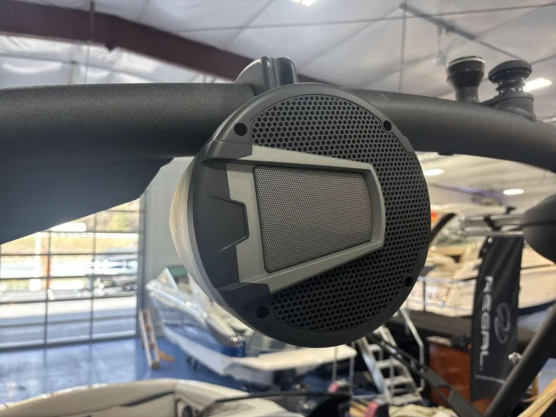 Slide: The Image of Close-up of a speaker on a 2025 Axis A225 boat in a showroom. - 18