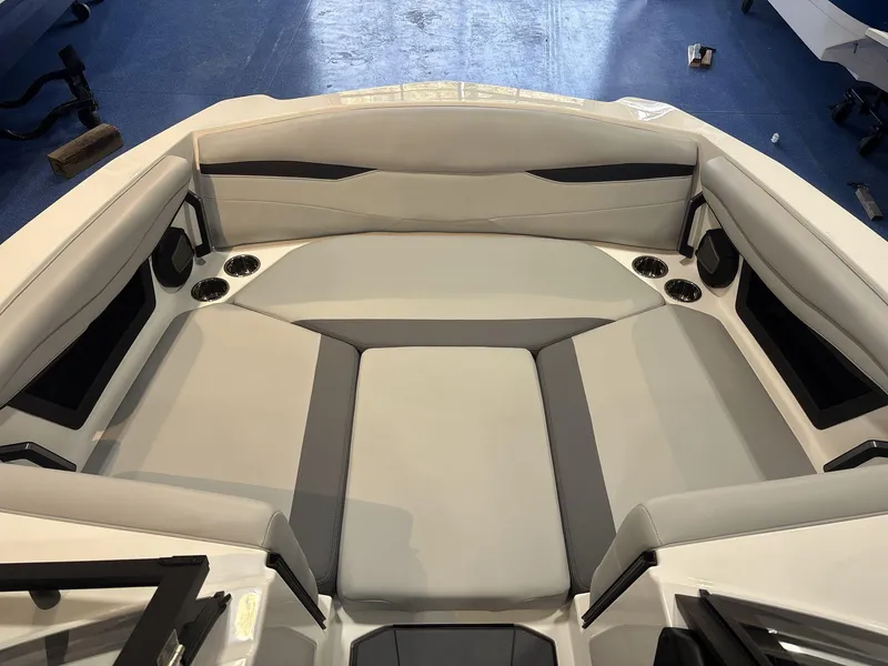 Slide: The Image of 2025 Axis A225 boat interior with gray seating and cup holders. - 7