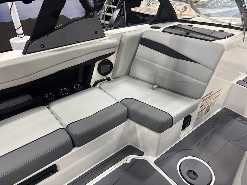 Slide: The Image of Interior seating of 2025 Axis A225 boat with gray upholstery and cup holders. - 9