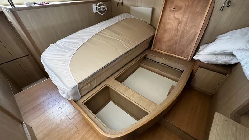 Slide: The Image of Interior of 2017 Aquila 44 Yacht with under-bed storage compartments open. - 41