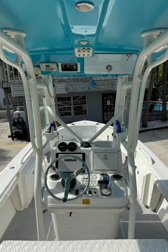 Slide: The Image of 2008 Everglades 243 CC boat interior with steering console and blue canopy. - 4
