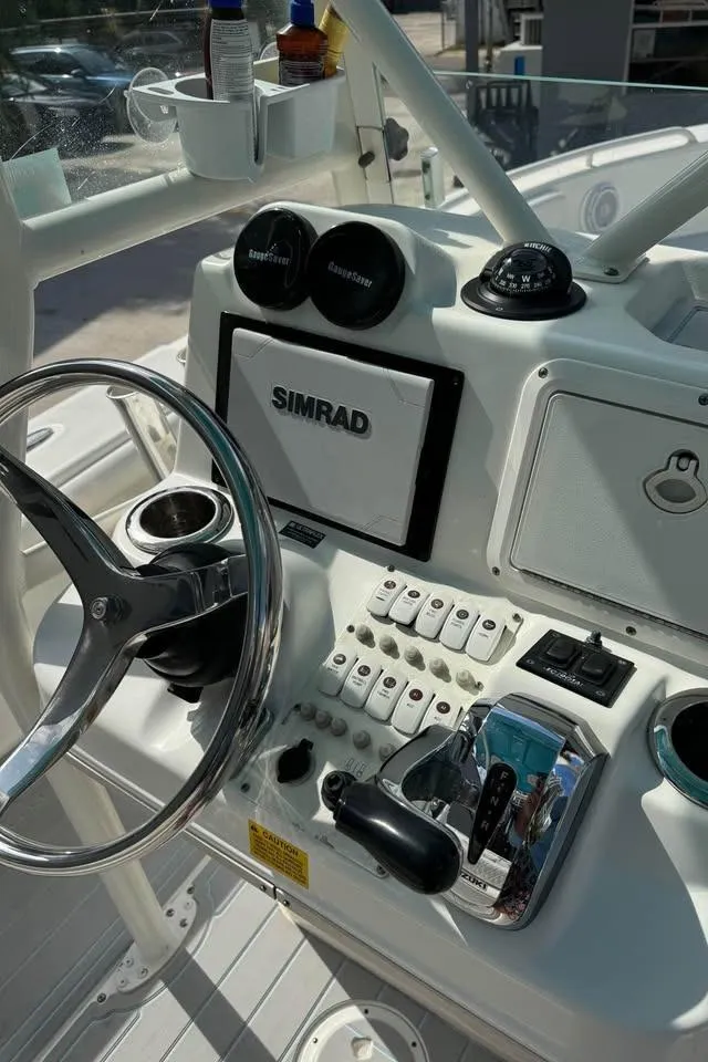 Slide: The Image of 2008 Everglades 243 CC boat dashboard with Simrad navigation system and steering wheel. - 6